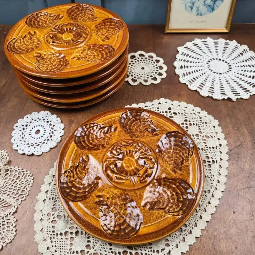 Pile d’assiettes à huîtres Sarreguemines, décor brun mordoré, avec une assiette au premier plan