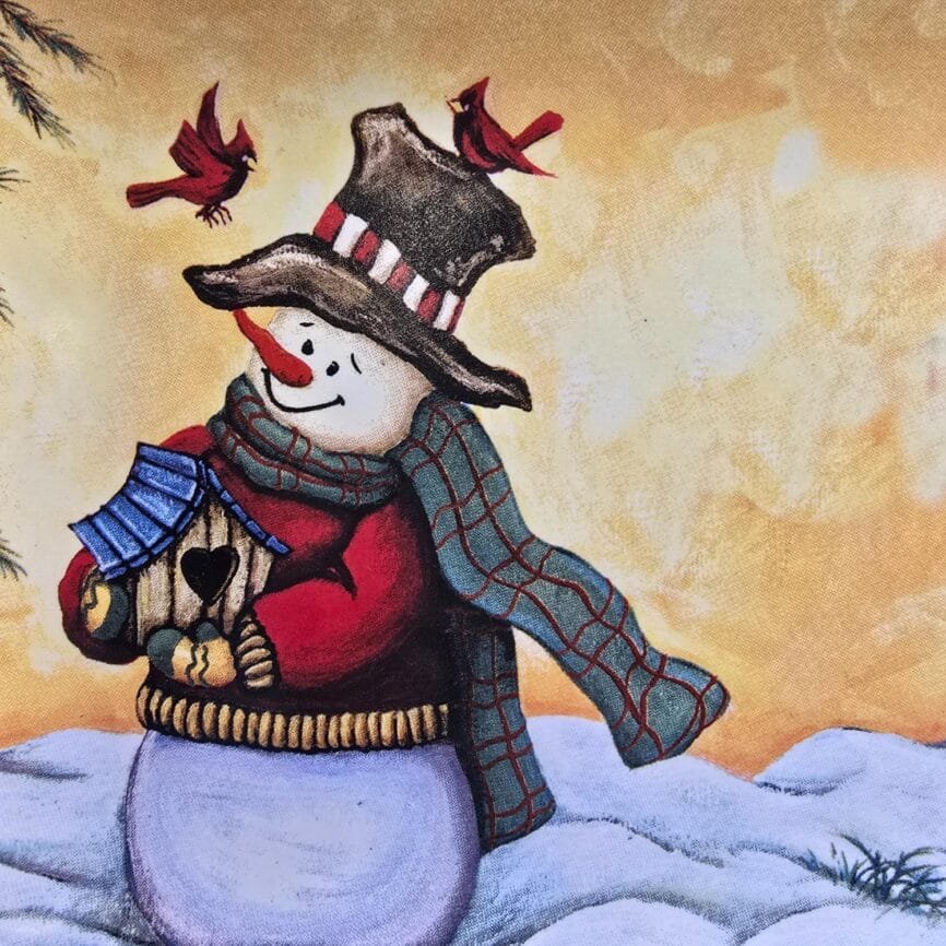 Détail du décor central avec bonhomme de neige et couleurs chaleureuses