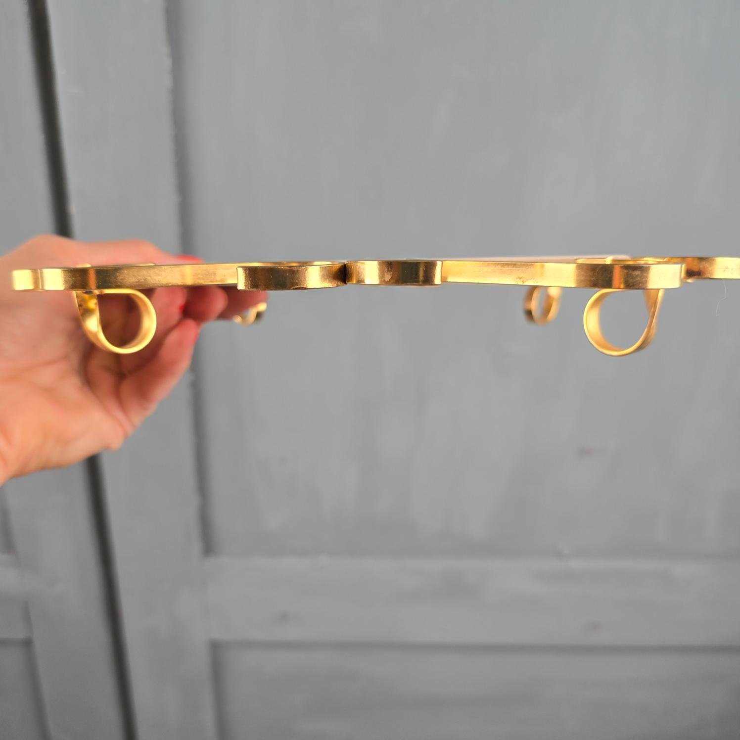 Dessous de plat vintage Villeroy & Boch, tenu en main de profil pour montrer le pièteman doré