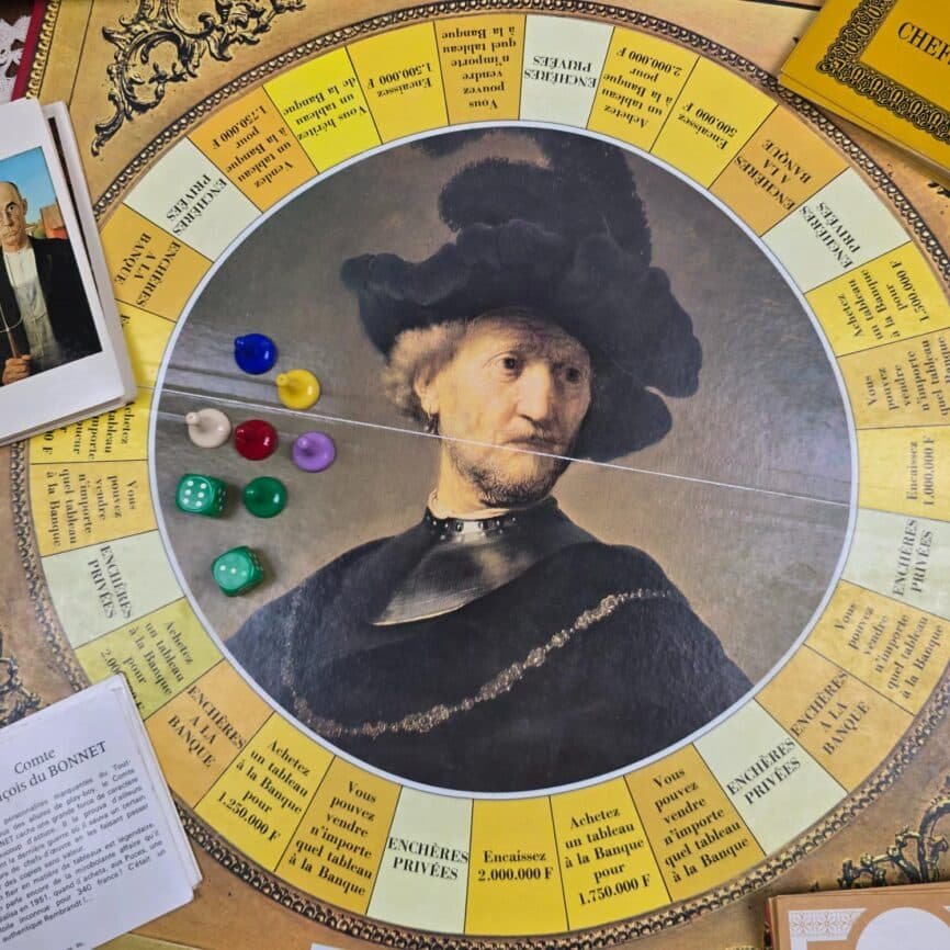 Plateau circulaire du jeu Chefs-d’œuvre avec pions colorés et portrait central