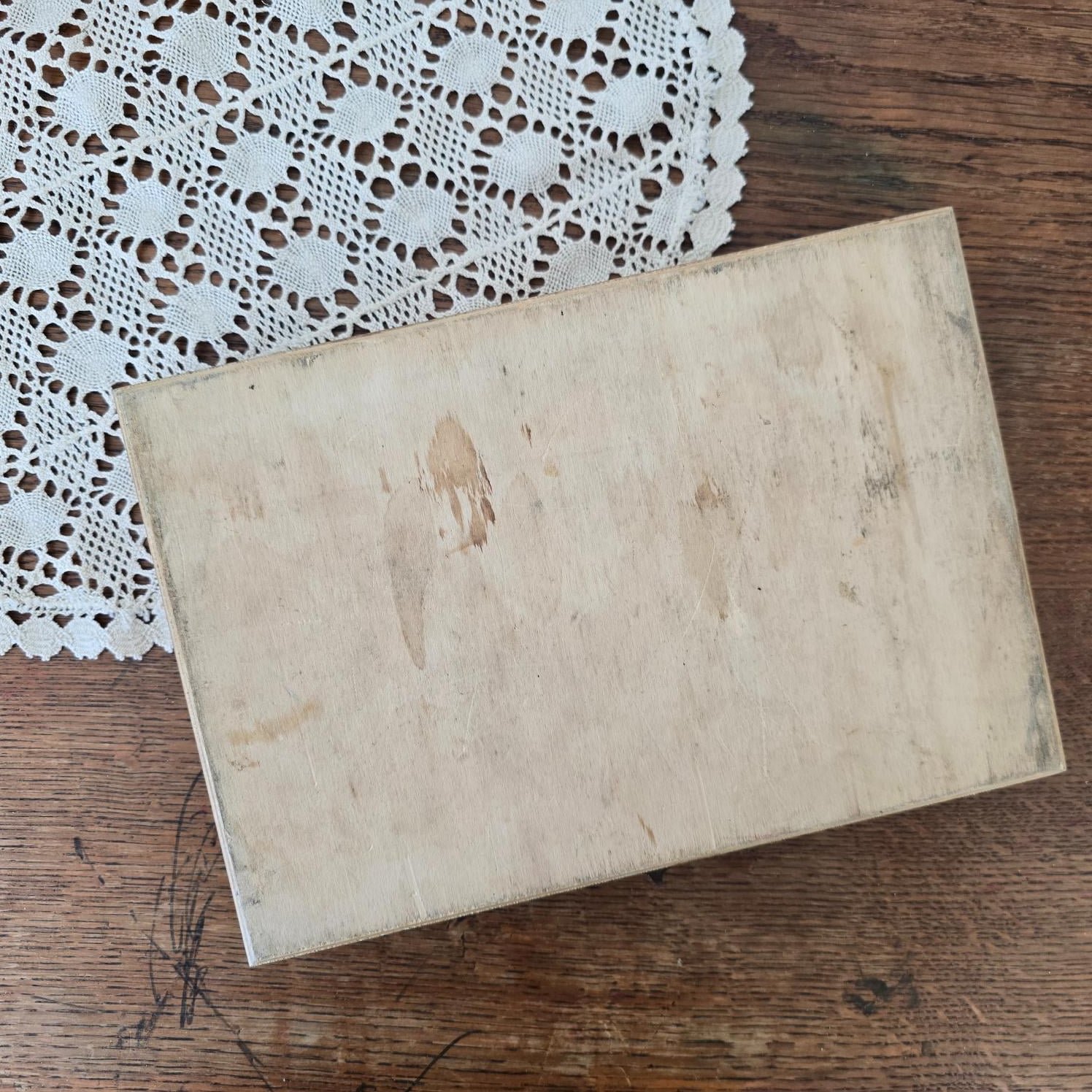 Dessous du coffret de cubes Jeujura en bois naturel avec traces d’usage