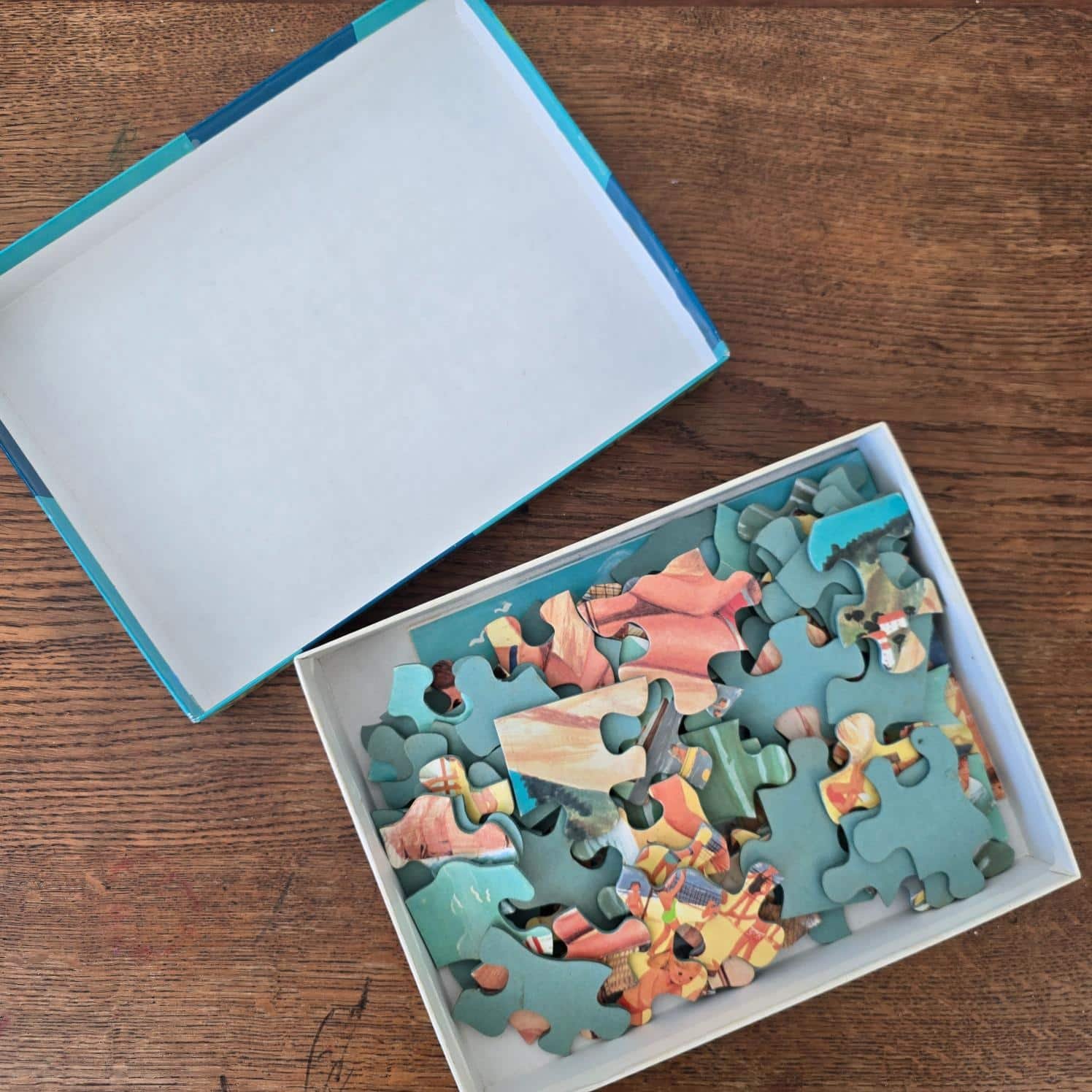 Boîte ouverte du puzzle vintage Au bord de la mer Fernand Nathan, avec les pièces à l’intérieur